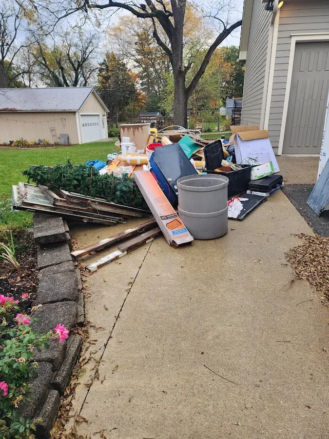 Dumpster being loaded with debris for 12 Yard Dumpster Rental in Auburn